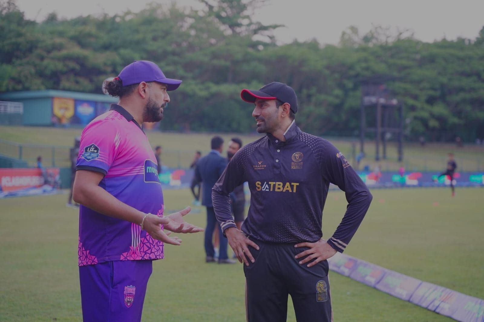 Two players talking pitch-side at a Rise T20 trial session