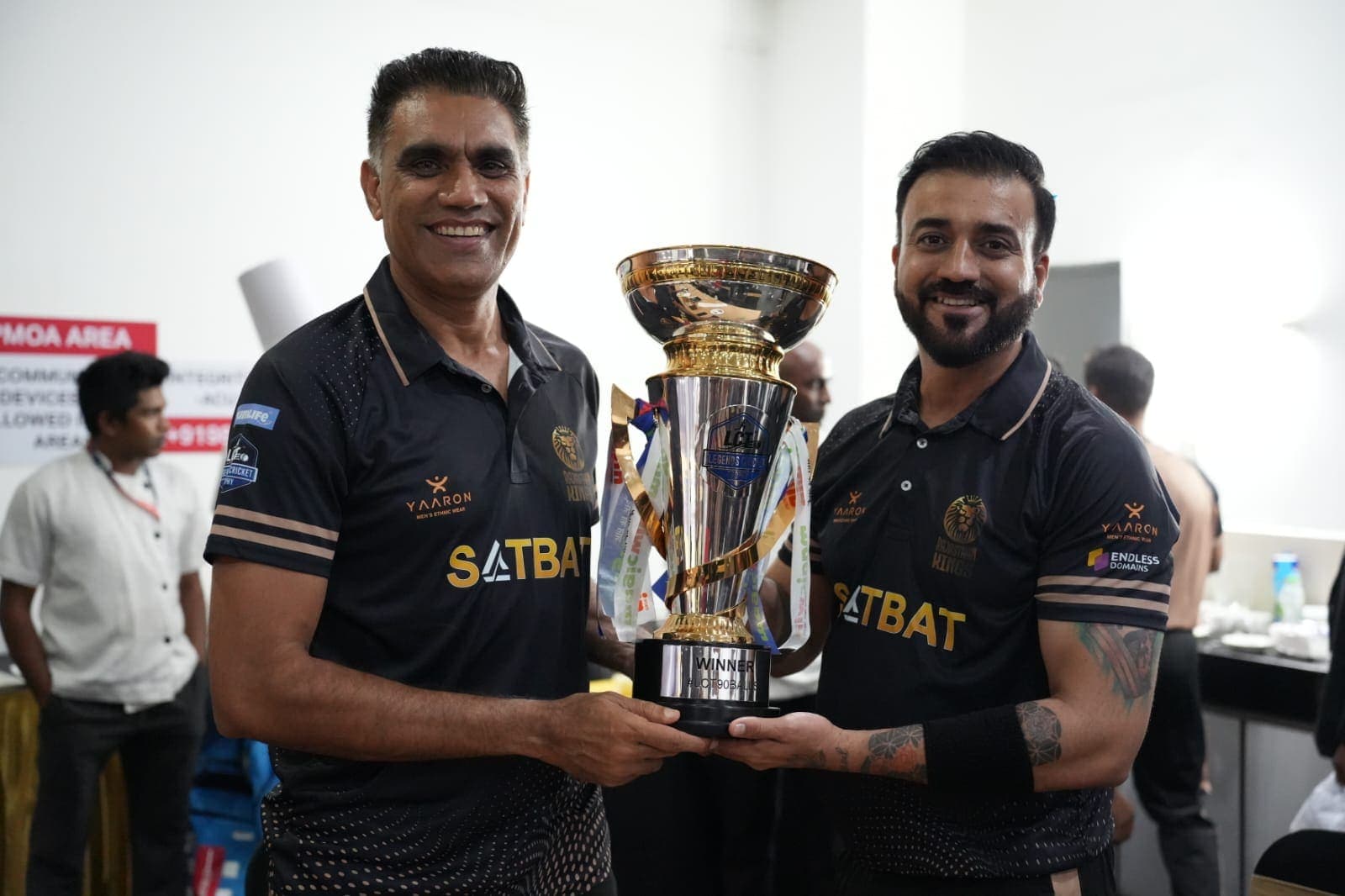Rise T20 founders holding a tournament winners' trophy.