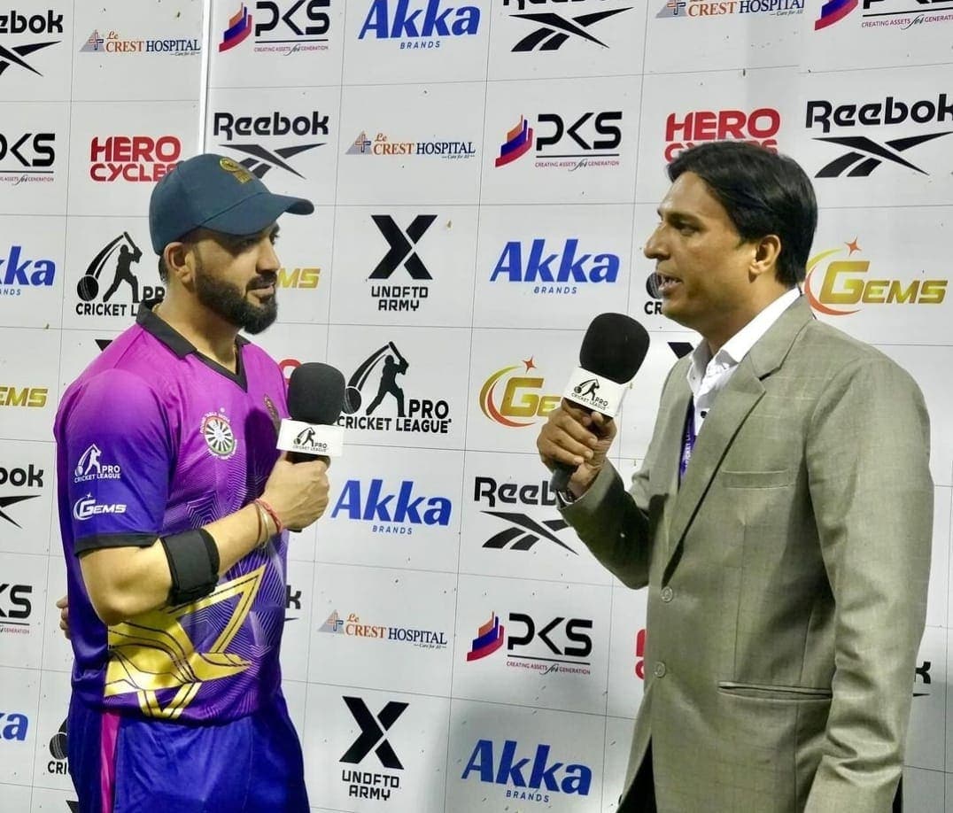 Founder giving a pitchside interview at the Pro Cricket League.